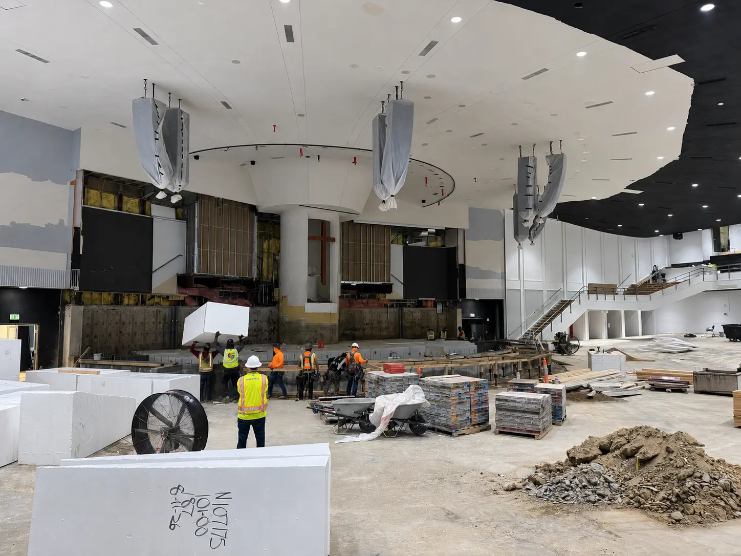 Crews working in the BRAVE Church auditorium during a commercial lighting renovation