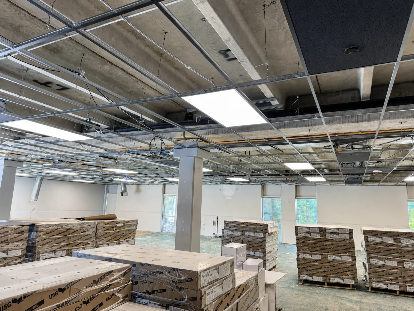 LED flat panels energized within an open commercial ceiling grid at BRAVE Church in Cherry Hills Village