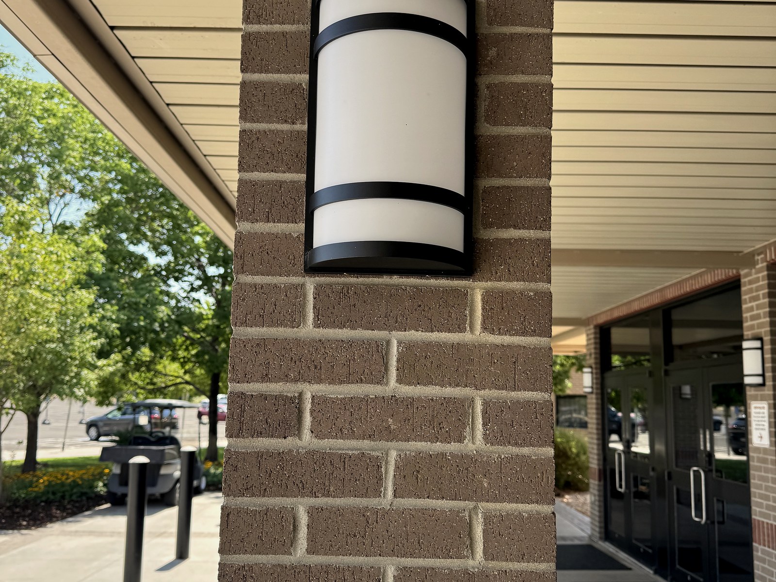 Exterior LED wall sconce on a brick column at the BRAVE Church entrance
