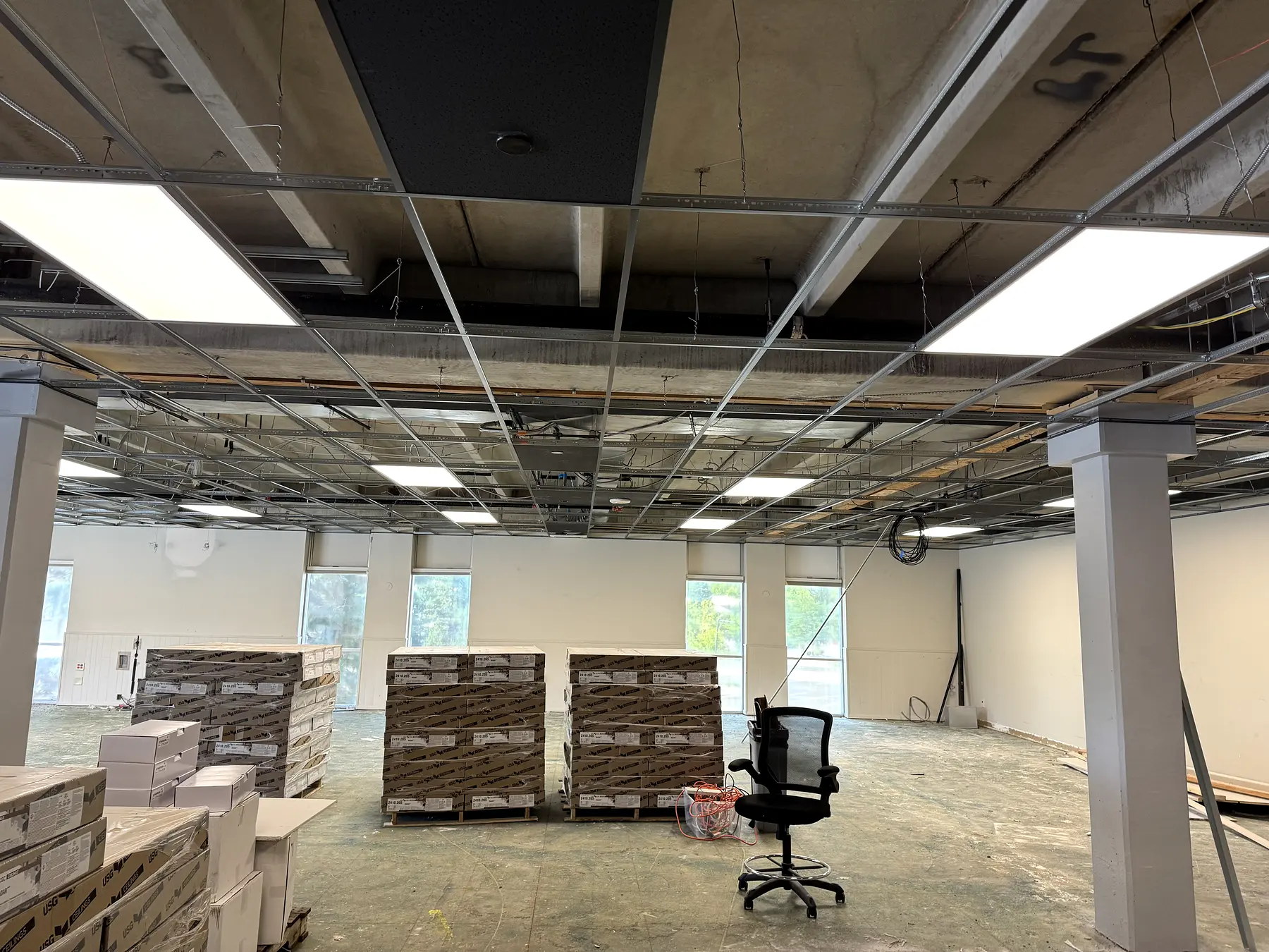 Commercial lighting installation progressing through an open office ceiling
