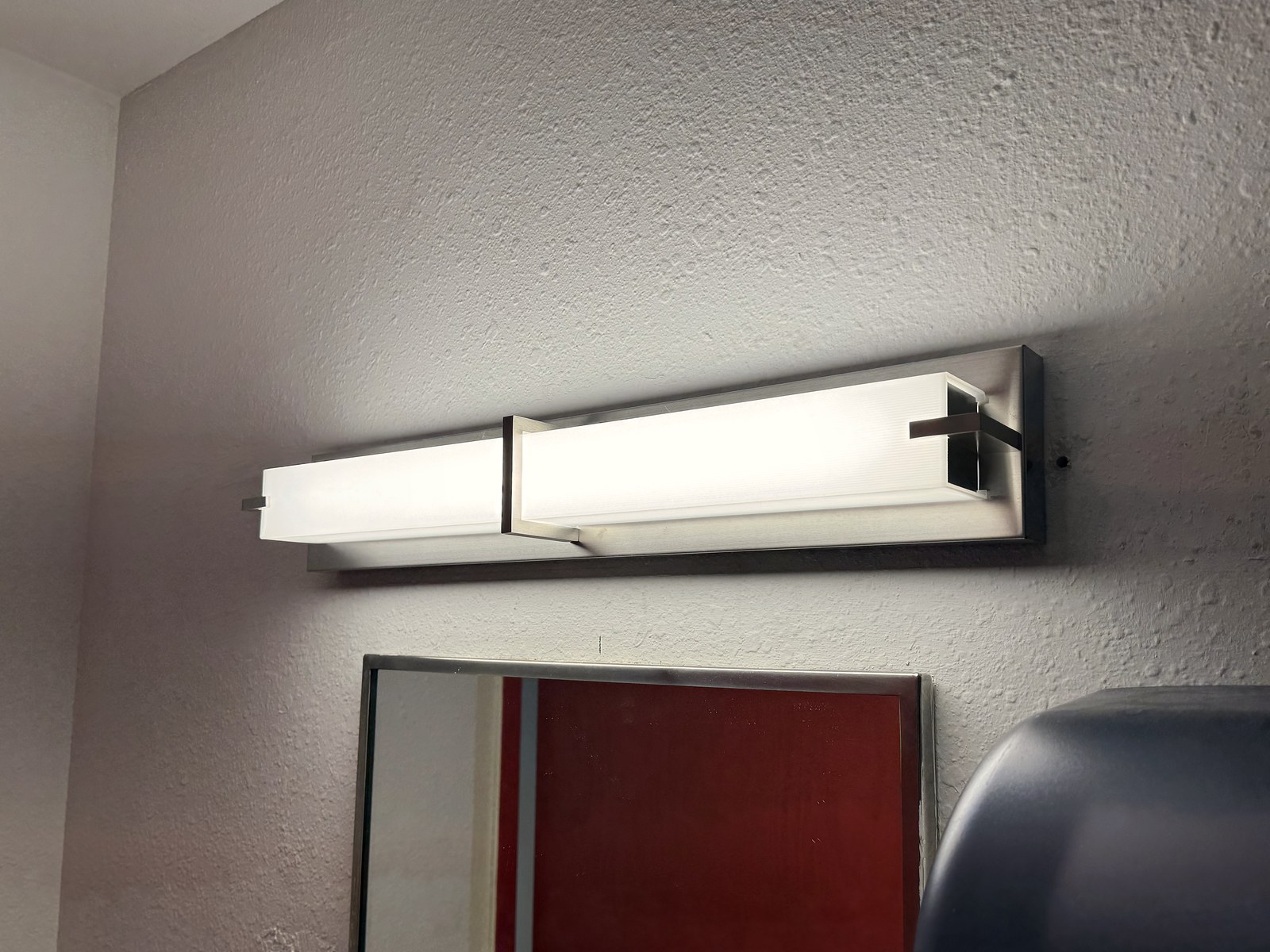 LED vanity fixture above a restroom mirror at BRAVE Church